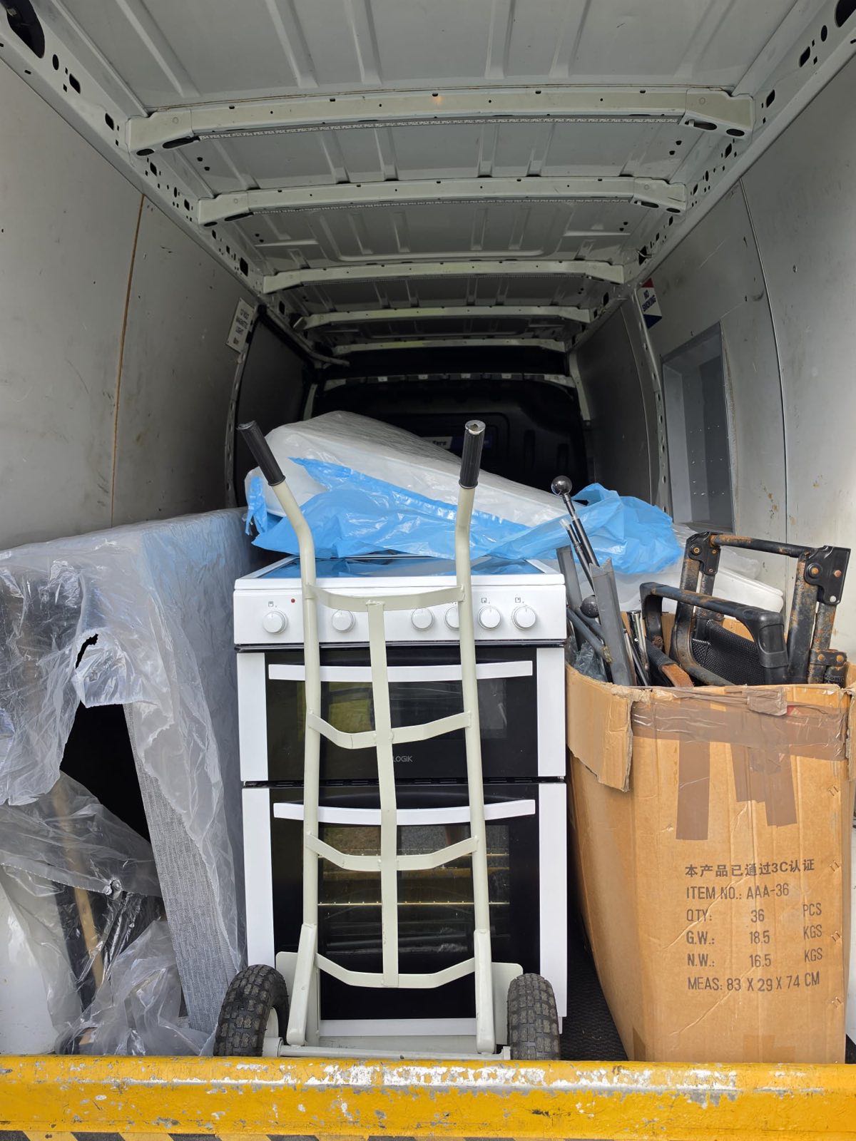 A cooker, mattress and other household items loaded in the van