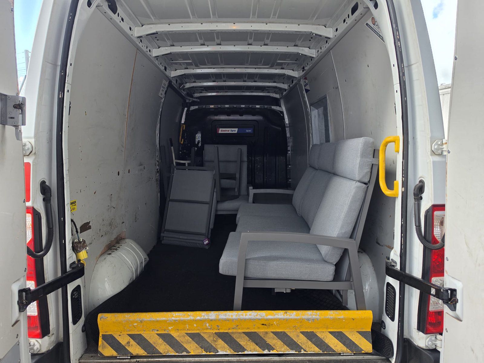 Outdoor furniture loaded securely in the back of the van